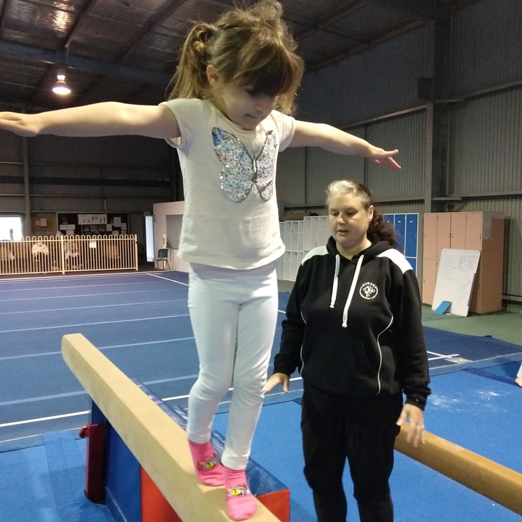 Gymnastics classes for toddlers are great for building confidence, like walking along the beam.